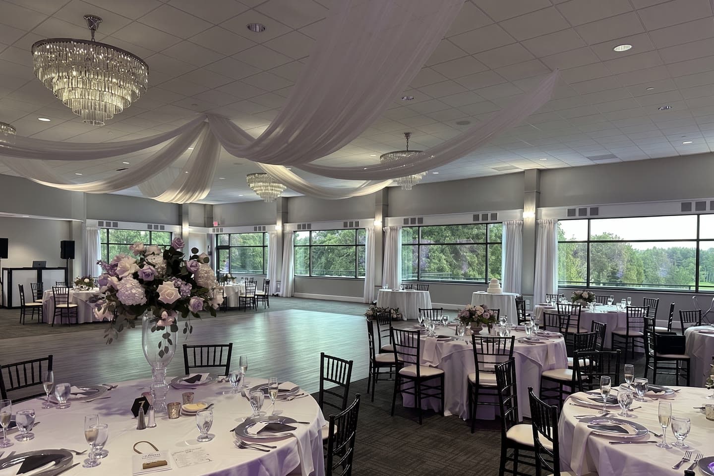 A ballroom set for a wedding under house lighting